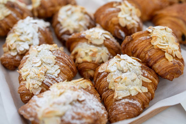 istock Freshly baked almond croissants on baking pan 1219190922