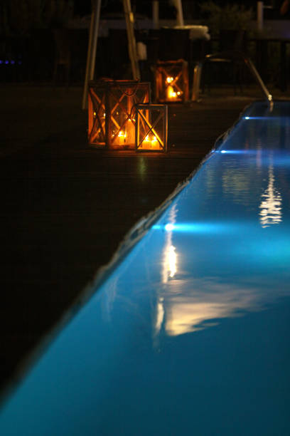 istock night swimming pool and candles 1219192330