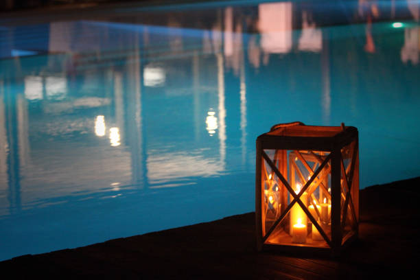 istock night swimming pool and candles 1219192354
