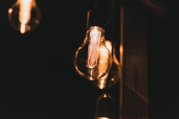 istock retro style incandescent lamps. Light bulbs in the dark. selective focus 1219193779