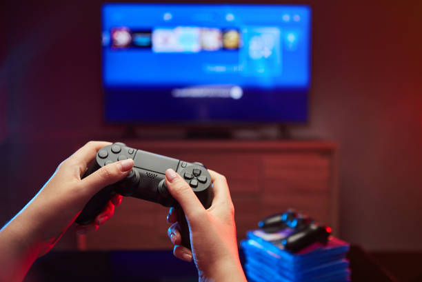 istock Gamer holding Gamepad, Controller or Videogame Joystick Console in hands. Close up, game concept 1219194036