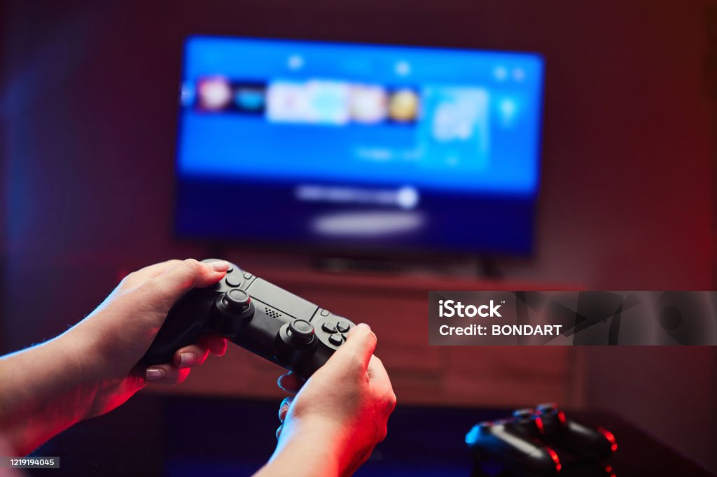 Gamer holding Gamepad, Controller or Videogame Joystick Console in hands. Close up, game concept Video Game Stock Photo