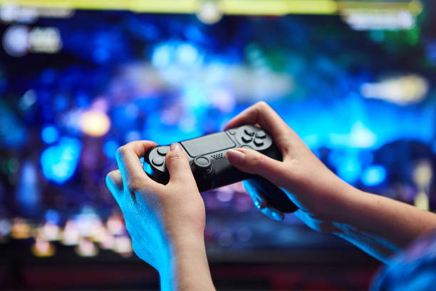 istock Gamer holding Gamepad, Controller or Videogame Joystick Console in hands. Close up, game concept 1219194187