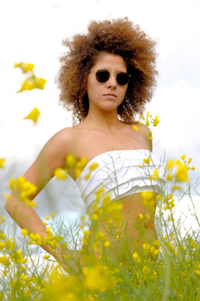 istock Casual Woman Standing In A Rapeseed Field 1219194341