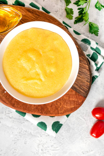istock Traditional cooked polenta in a white bowl on a gray concrete table 1219196174
