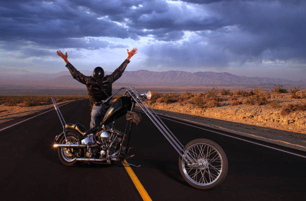 istock Biker Celebrating Freedom and Victory in Storm desert 1219197245
