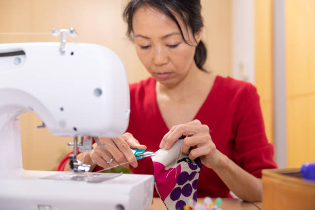 istock Japanese woman making mask at home 1219200768