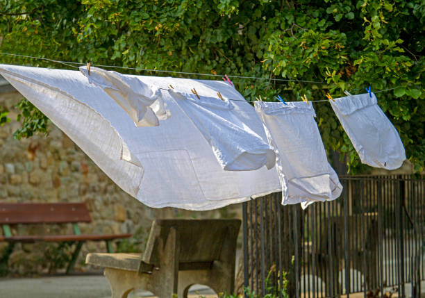 Xhosa lady hanging washing on a line in rural Mthatha, Transkei, South Africa.