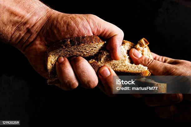 Two People Fighting Over Piece Of Bread Stock Photo - Download Image Now - Famine, Poverty, Hungry