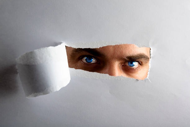 istock I see you! - man looking through keyhole 121920292