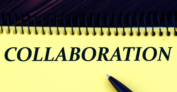 istock COLLABORATION word written in a notebook pen on a yellow background 1219203685