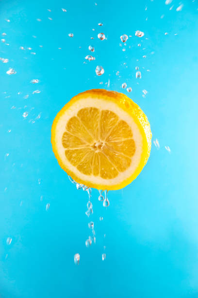 istock Yellow lemon in flight with drops of juice 1219204189