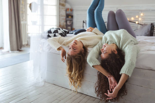 istock Two young women friends sharing happy time together 1219204190