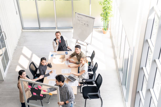 istock Group of businessman brainstorm to solve problem, presentation new idea. People discuss in teamwork on new challenge topic in meeting room. Business finance and communication planning top view concept 1219205175