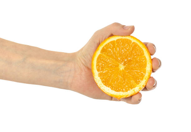 istock Fresh orange in hand isolated on white background 1219205249