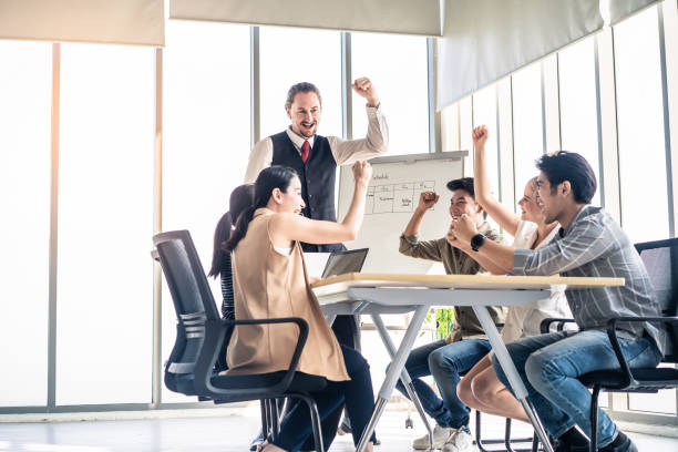 istock Group leader man and teamwork brainstorm to solve problem and presentation new idea. Manager cheer up people for new project in meeting room. Business finance and communication planning concept. 1219205363