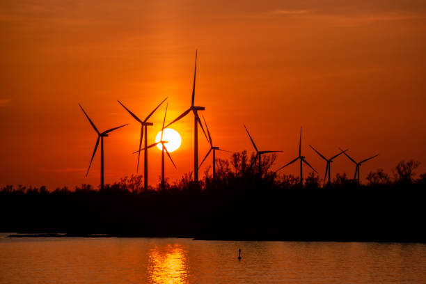 istock Moerdijk Netherlands, sunset winth windmills by the lake Vokerak river in Holland windmill energy sunset 1219206328