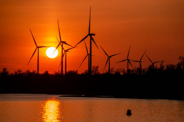 istock Moerdijk Netherlands, sunset winth windmills by the lake Vokerak river in Holland windmill energy sunset 1219206576
