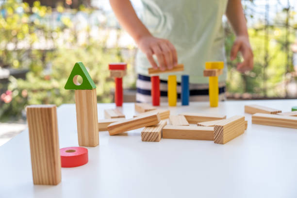 istock Little boy builder folding wooden blocks 1219207001