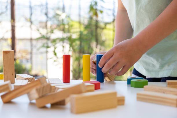 istock Little boy playing with wooden blocks 1219207186
