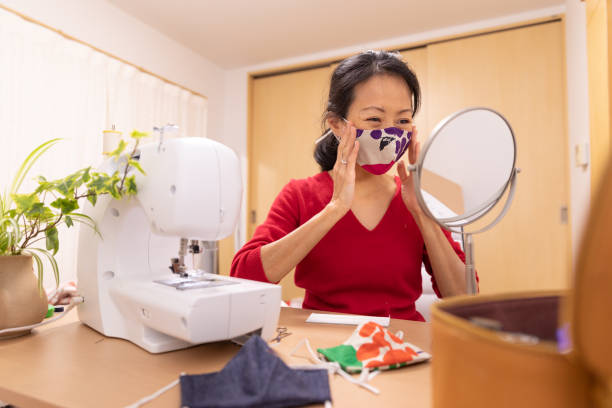 istock Japanese woman making mask at home 1219208770