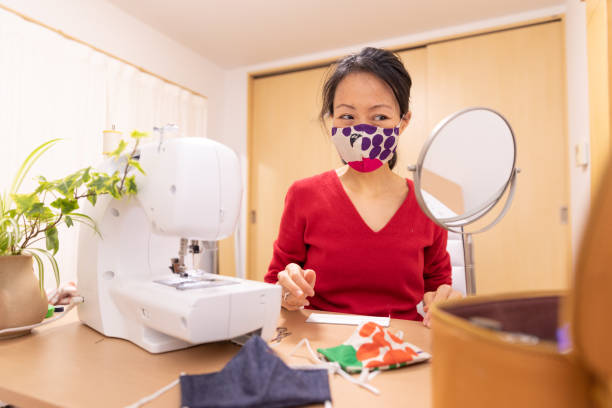 istock Japanese woman making mask at home 1219209335