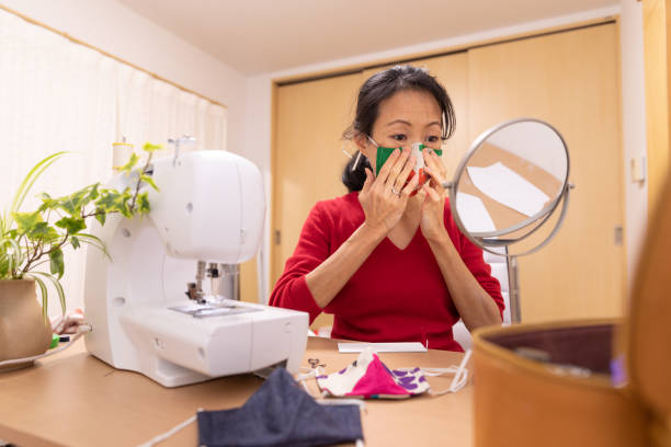 istock Japanese woman making mask at home 1219209989