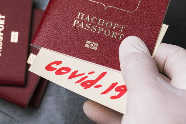 istock Text in Russian: passport. The doctor holds a document with an embedded diagnosis. Concept on the topic of checking Russian passengers in the passport control zone 1219211393