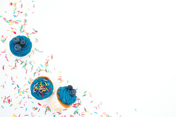 Blueberry muffins with colored sweet sprinkle isolated on white background. Flat lay, top view