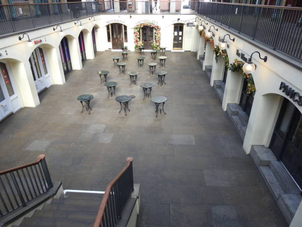 Coronavirus London Lockdown - Covent Garden market is empty during the coronavirus pandemic London / UK - March 23rd 2020: London's normally busy Covent Garden and Neal Street, popular tourist destinations are nearly empty as people are told to  self isolate during the COVID-19 coronavirus paternoster square stock pictures, royalty-free photos & images