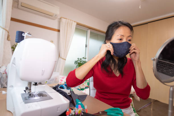 istock Japanese woman making mask at home 1219214465