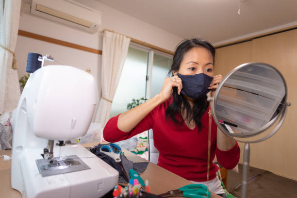 istock Japanese woman making mask at home 1219214564