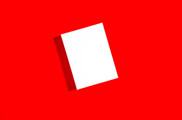 istock Mockup of closed blank square book at white textured paper 1219214606