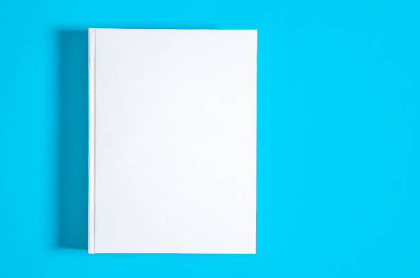 istock Mockup of closed blank square book at white textured paper 1219214608