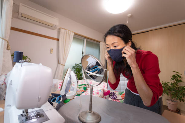 istock Japanese woman making mask at home 1219215355