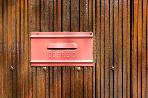 Brazilian mailbox with a wooden background.