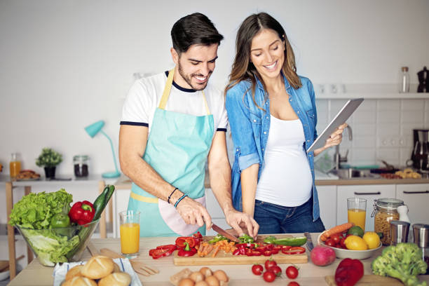 istock Happy couple is cooking in a kitchen 1219215537