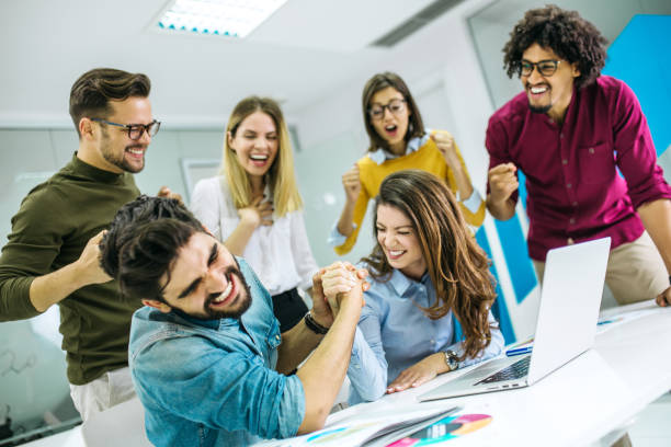 istock Group of students looking at laptop and brainstorming 1219216684
