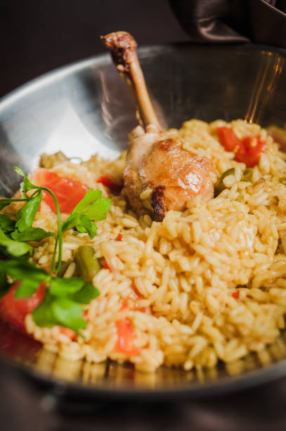 istock rice with chicken, seafood and tomatoes 1219216796