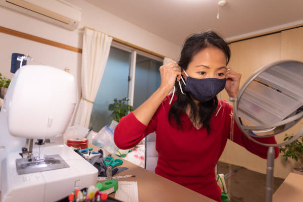 istock Japanese woman making mask at home 1219216936