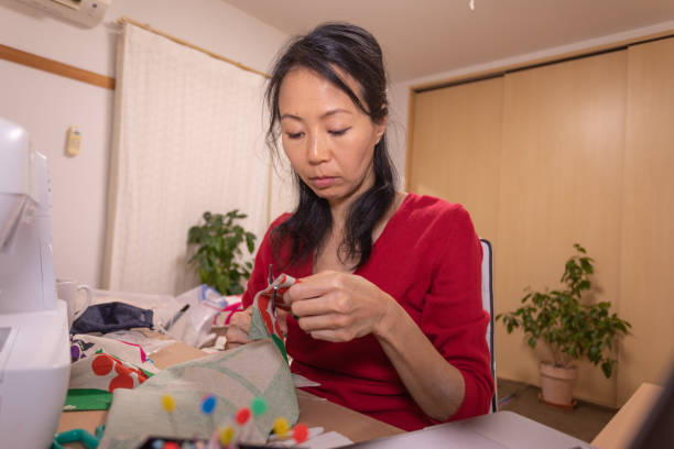 istock Japanese woman making mask at home 1219217516