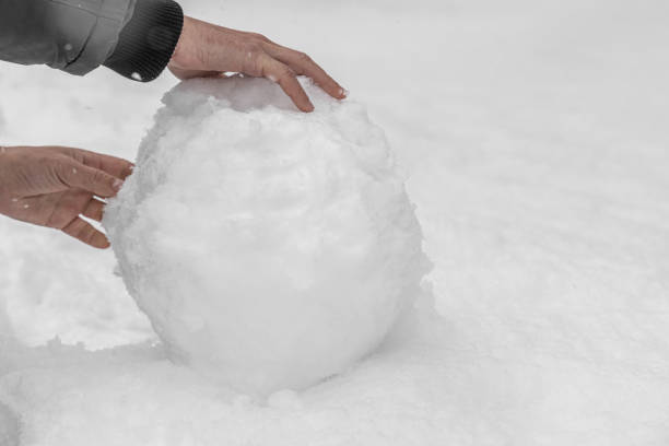 istock A man makes a snowman in a winter day 1219218436