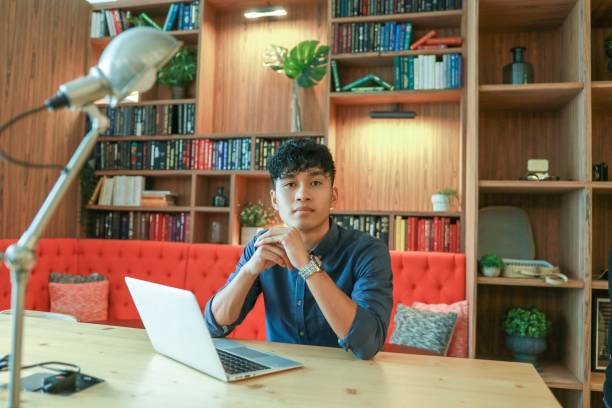 istock Young asian is working on laptop in the library 1219219743