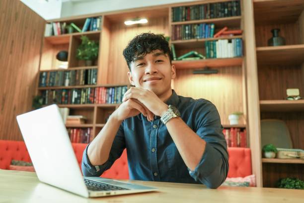 istock Young asian is working on laptop in the library 1219219744