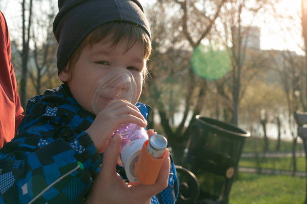 istock A small boy who suffering from illness bronchial asthma getting treatment with aerosol inhaler outdoors. 1219222076