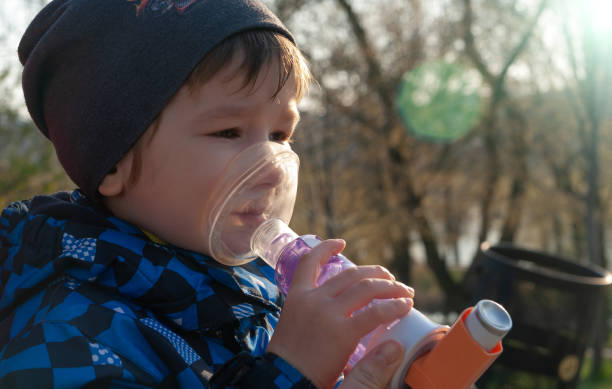 istock A small boy who suffering from illness bronchial asthma getting treatment with aerosol inhaler outdoors. 1219222611
