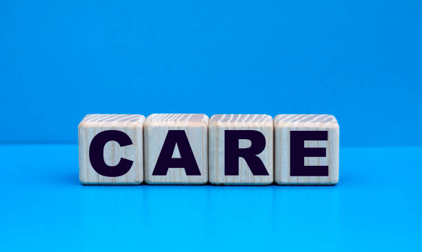 istock concept word CARE on cubes on a blue background 1219223047