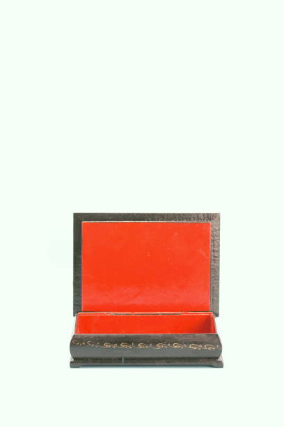 istock Black with gold painted empty lacquered wooden casket stands open. Inside is red 1219223347