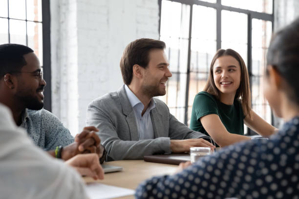 istock Happy multiethnic colleagues laugh brainstorming at briefing 1219224579