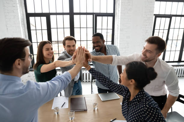 istock Excited diverse colleagues give high five celebrate success 1219224596